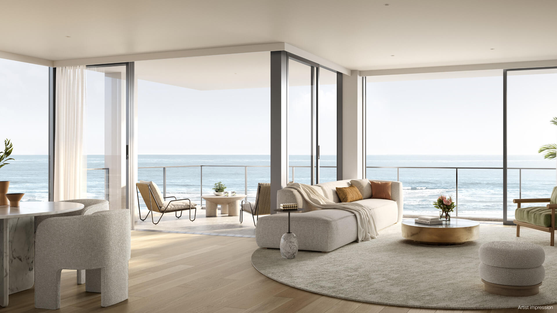 Modern open plan living with glass windows looking out to ocean